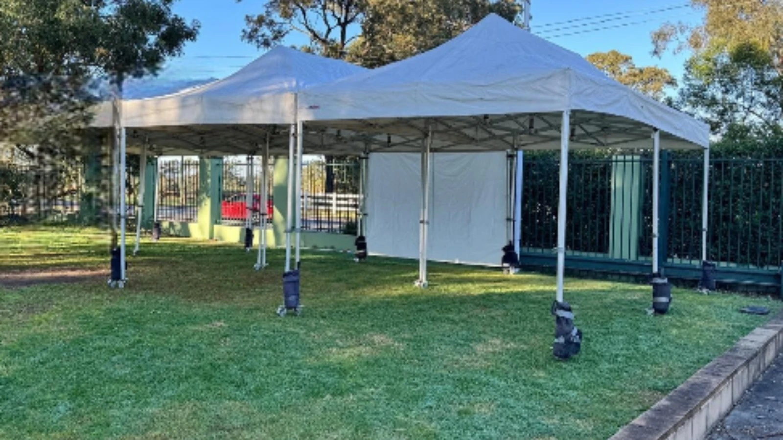 6m x 6m pop-up marquee hire Sydney set up in a residential backyard for a birthday party with chairs and tables inside